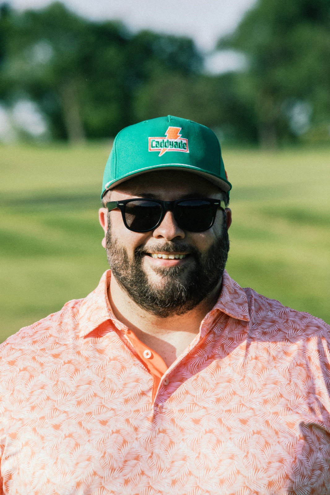 League member in a floral shirt and green cap on the fairway