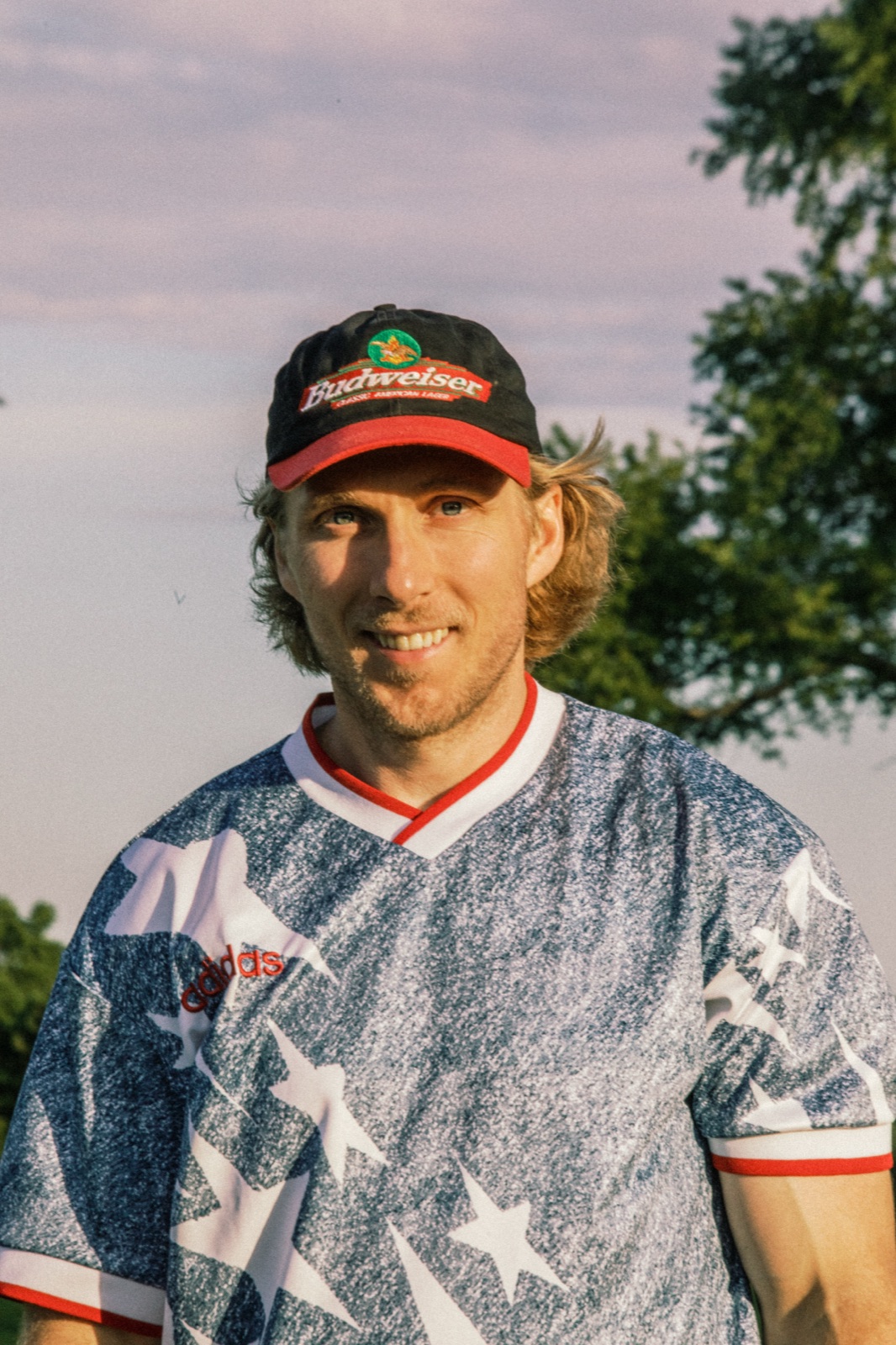 Smiling league member in a star-pattern jersey on the course