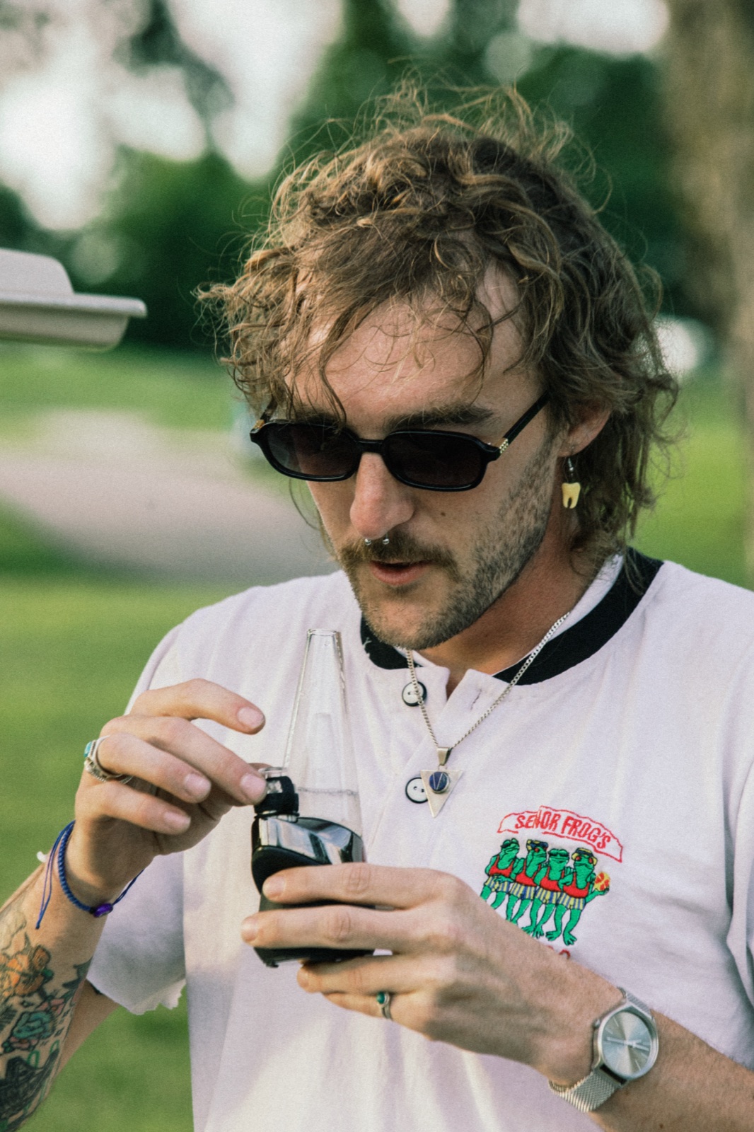 League member in sunglasses and a graphic tee at golden hour