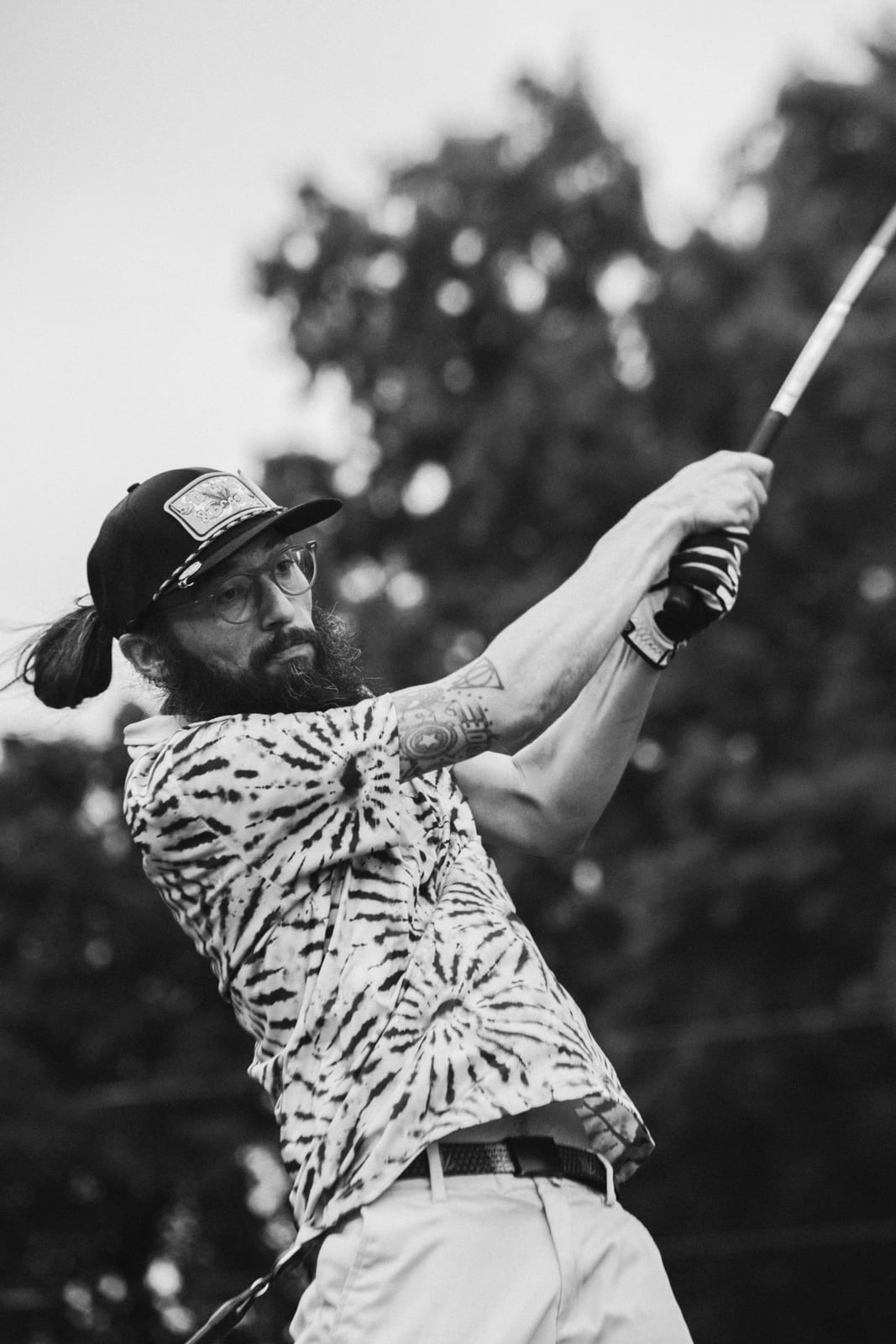 Tie-dye shirt, tattoos, and a full follow-through on the tee
