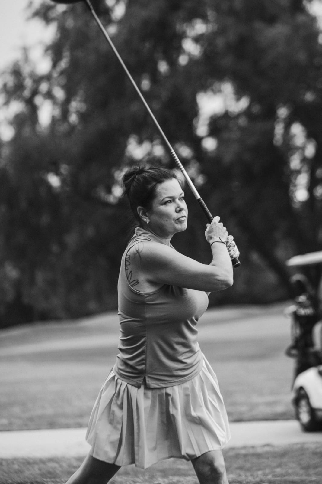 Player following through on a drive beside the cart path