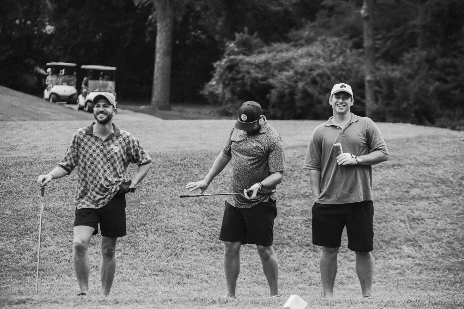 Three league members laughing on the fairway between shots