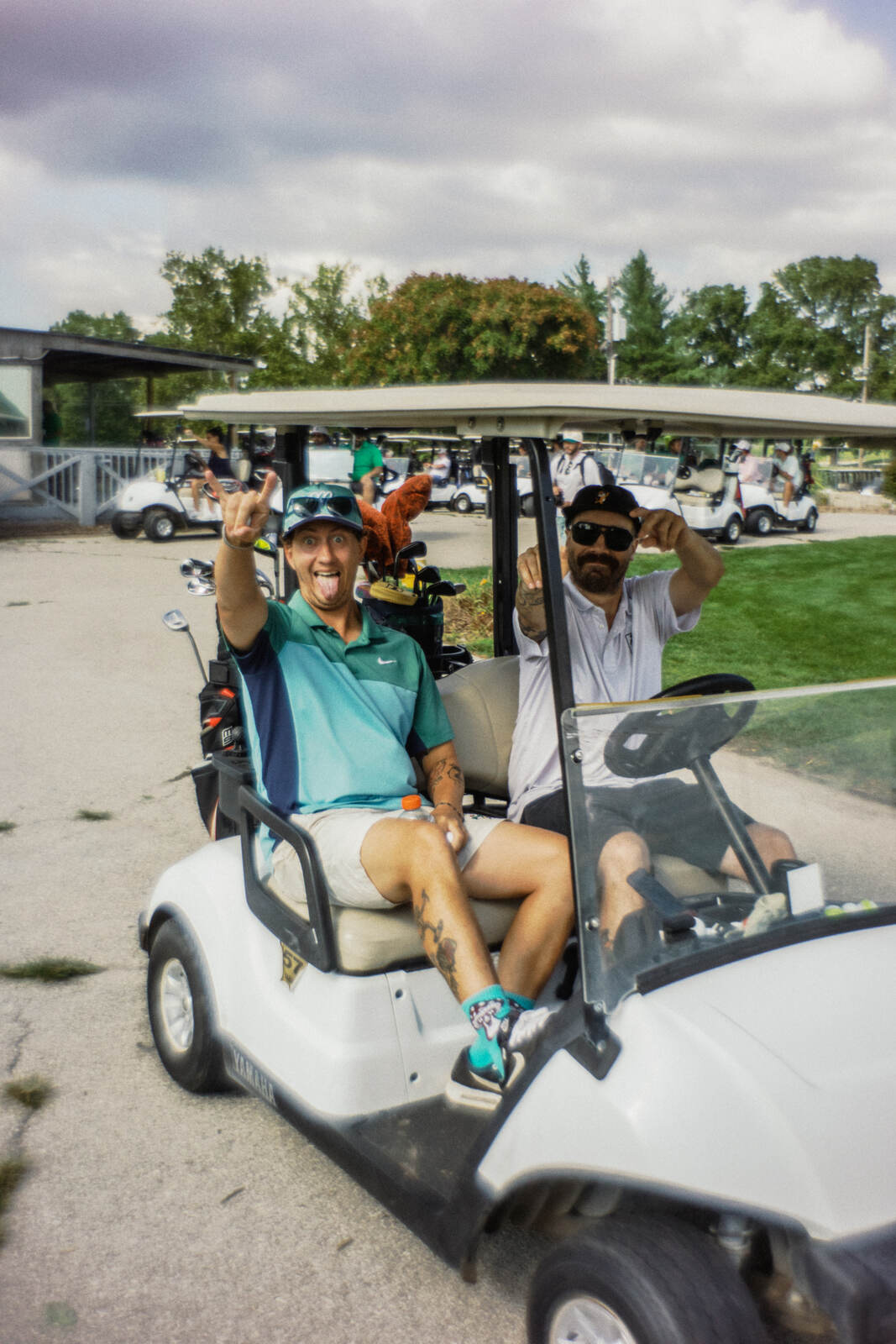 Two league members clowning for the camera from a parked cart