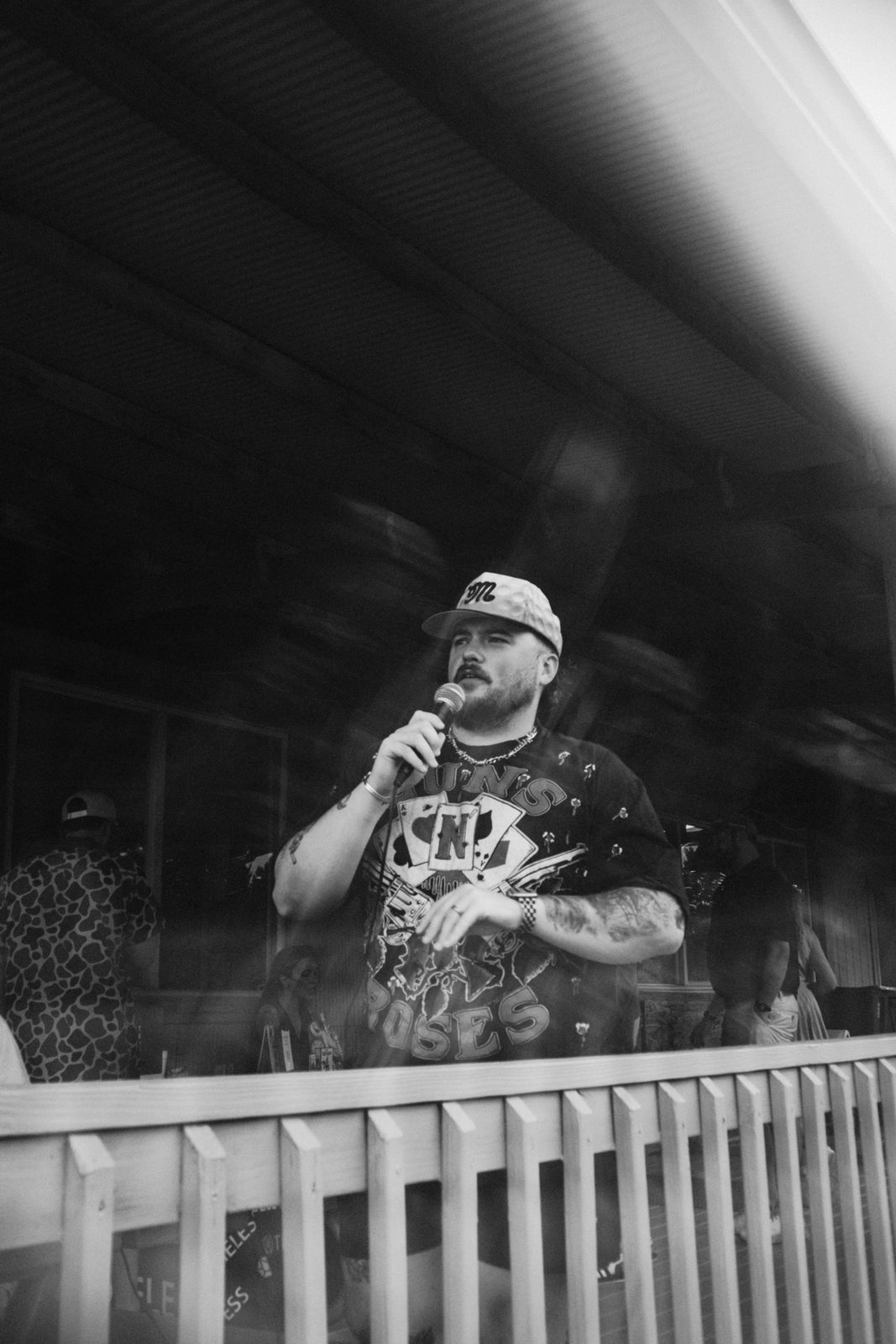 League member on the microphone behind the clubhouse rail
