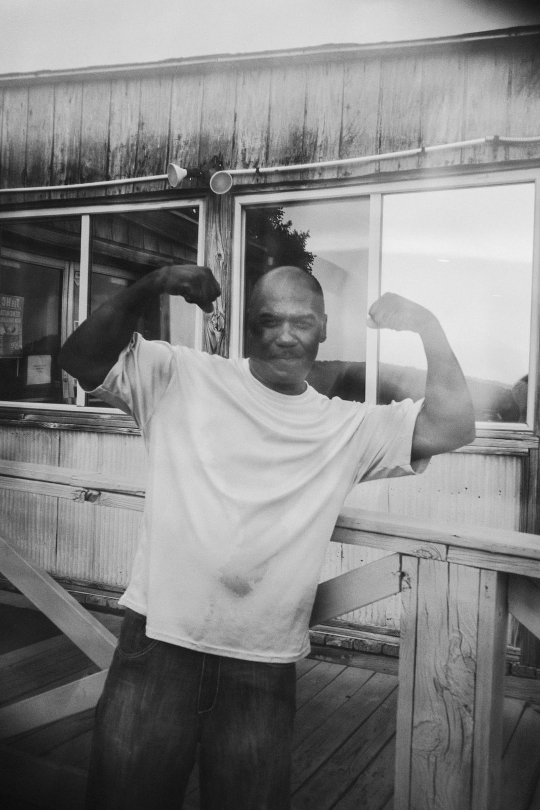 League member leaning out of the clubhouse window with both arms thrown wide